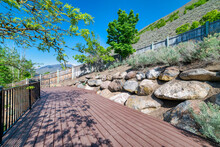 Wooden Deck With Metal Railings At The Side Of The Mountain