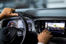 Close Up Of Man Touching Multimedia Screen Of Luxury Car While Sitting Inside. Male Customer Testing Modern Innovative Dashboard Before Buying Vehicle. Selling And Purchase Concept.