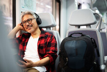 Senior Man Traveling By Train. Man Listening The Music While Enjoying In Travel