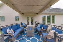 Outdoor Deck With String Lights, Barbecue Griller And Fire Pit Table With Blue Fire Glass