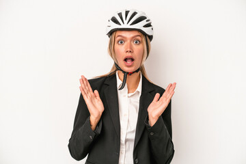 Poster - Young caucasian business woman wearing a bike helmet isolated on white background surprised and shocked.