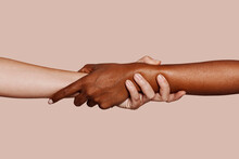 Close Up Multiracial Woman Couple With Black And Caucasian Hands Holding Each Other Wrist In Tolerance Unity Love And Anti Racism Concept.