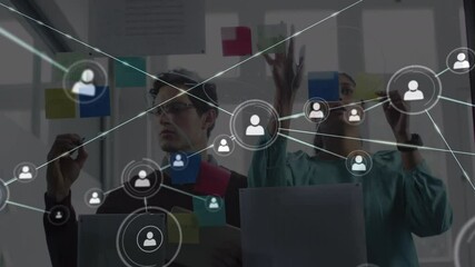 Canvas Print - Animation of network of people icons over male and female colleague brainstorming in office