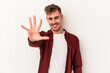 © Asier - Young caucasian man isolated on white background smiling cheerful showing number five with fingers.