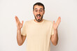 © Asier - Young caucasian man isolated on white background celebrating a victory or success, he is surprised and shocked.