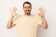 © Asier - Young caucasian man isolated on white background showing number ten with hands.