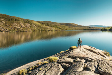 Wall Mural - Man hiking near a beautiful lake