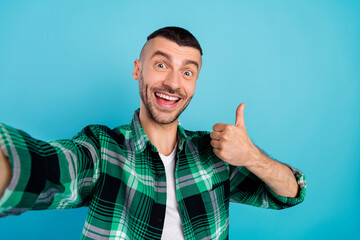 Sticker - Photo of cheerful happy crazy man make selfie show thumb up smile enjoy isolated on blue color background