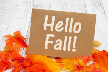 Sticker - Hello Fall message on greeting card on weathered wood with fall leaves