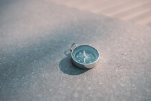 Round Stylish Compass On Concrete Background, Search Direction With Compass In Summer Mountains, Point Of View.