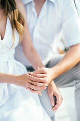 Wall Mural - the bride and groom tenderly hold hands between them love