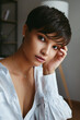 Portrait of beautiful young woman with short hair and and nice makeup on her face