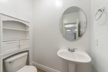 Wall Mural - White powder room interior with toilet and sink with oval mirror