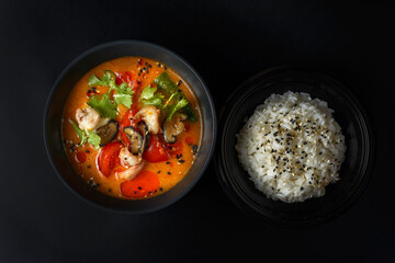 tom yam on a black background