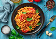 Pasta with bolognese sauce, a traditional Italian dish on a blue background.