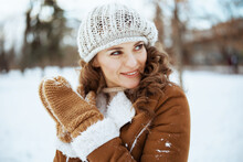 Smiling Stylish Woman Outside In City Park In Winter