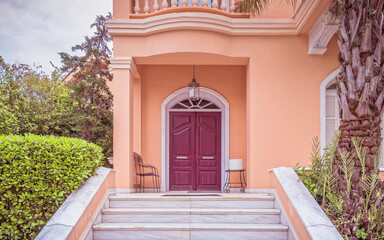 Wall Mural - elegant house front marble stairs and arched entrance bordeaux door, Athens Greece