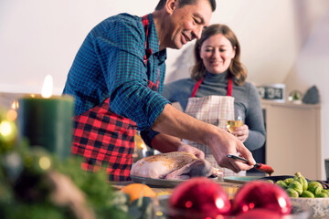 Man and woman cook together for Christmas traditional dinner 