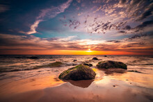 Group Of Small Rock Formations And A Dramatic Sunset Sky Over The Tranquil Baltic Sea In Lithuania