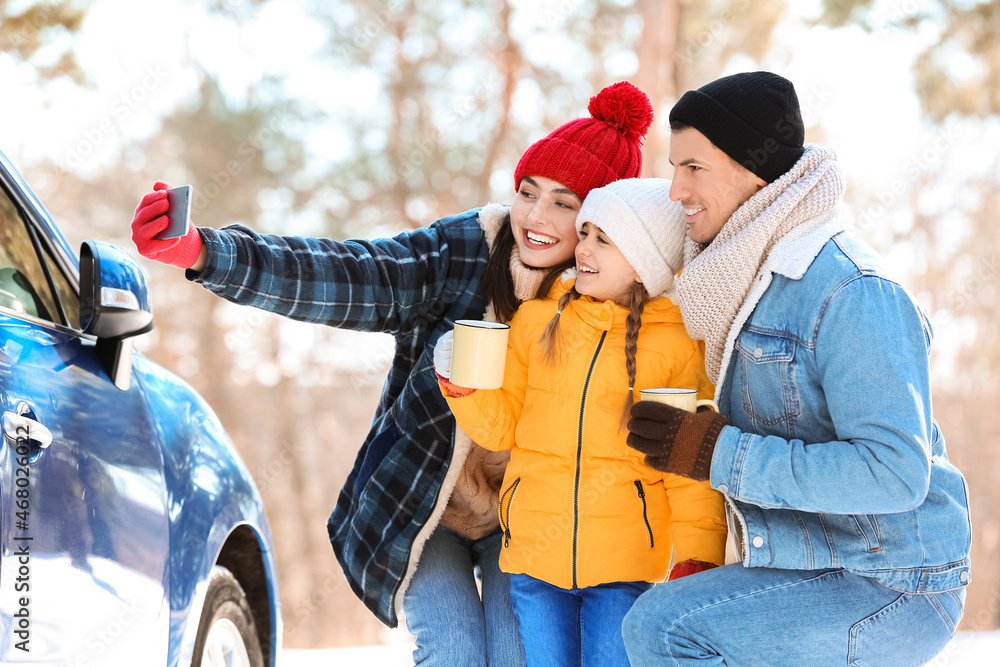 Happy family taking selfie on winter day