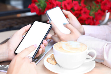 Sticker - Women using mobile phones in cafe, closeup