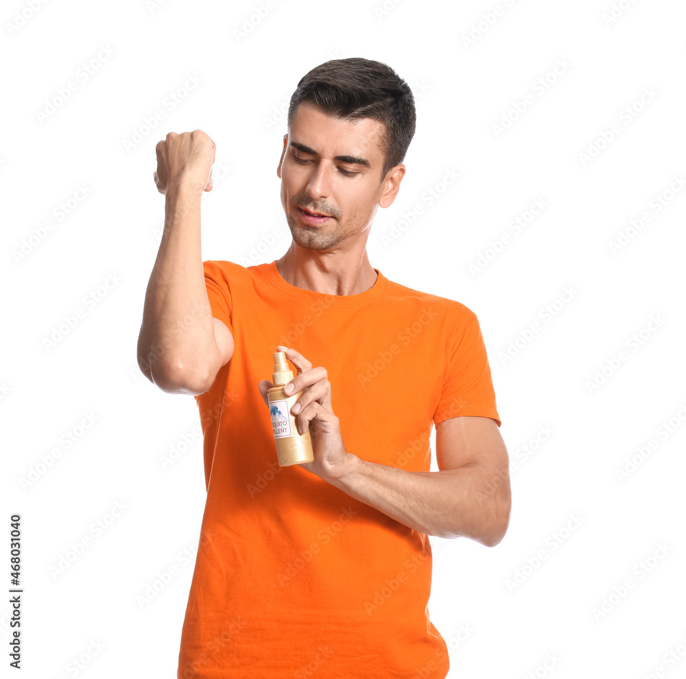 Young man with mosquito repellent on white background
