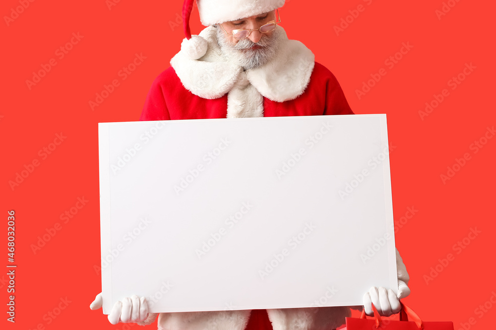 Santa Claus with blank poster on color background