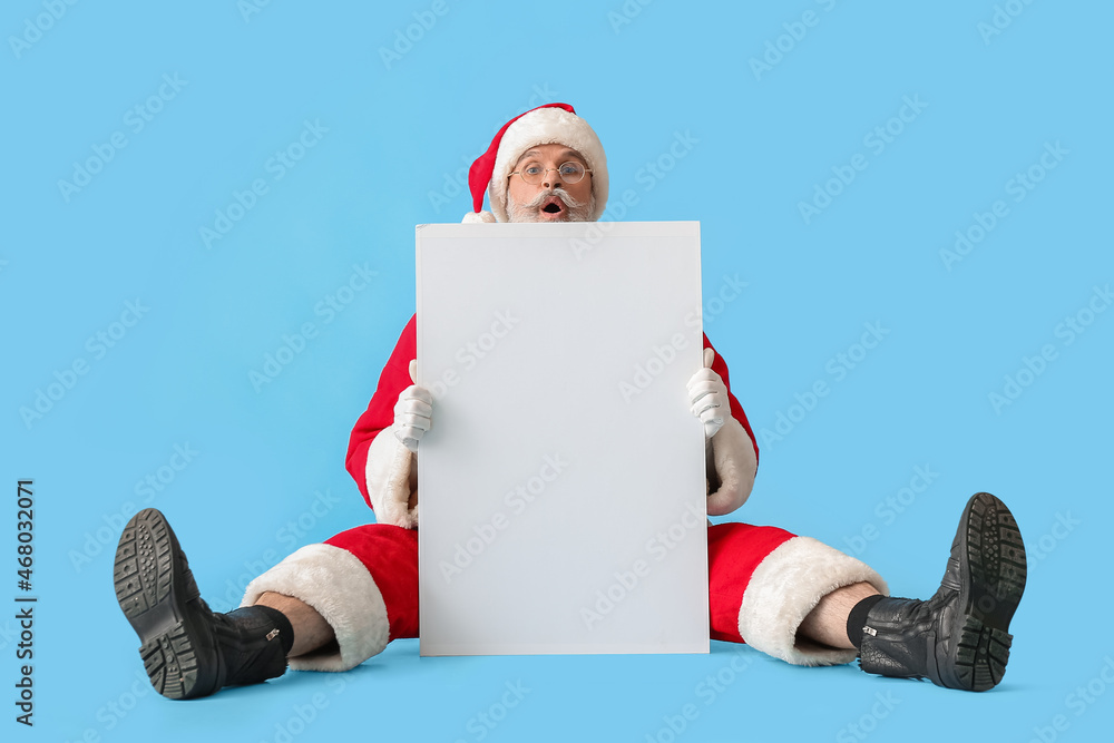 Santa Claus with blank poster on color background