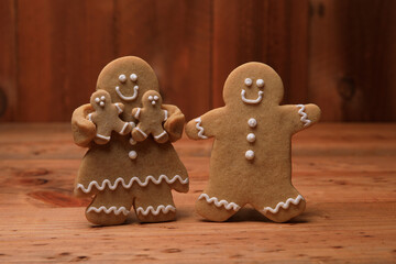 Wall Mural - Family of Gingerbreads with 2 kids on Holiday Christmas Background