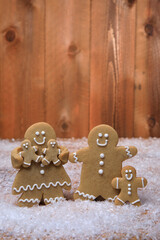 Wall Mural - Family of Gingerbreads with 3 kids on Holiday Christmas Background