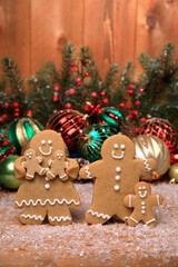 Wall Mural - Family of Gingerbreads with 3 kids on Holiday Christmas Background