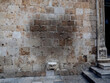 Impression left by people trying to get good luck by balancing on the stone Maskeron legend gargoyle set in a wall of Dubrovnik, Croatia. 