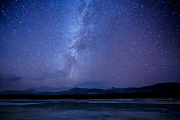 starry sky over a frozen winter lake. milky way. sikhote-alin biosphere reserve in the primorsky ter