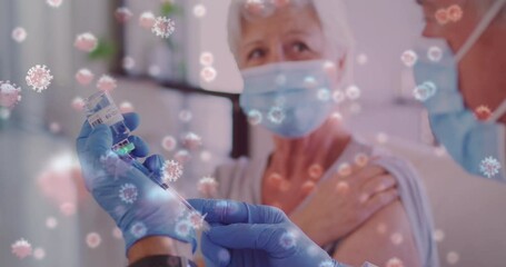 Canvas Print - Animation of covid 19 cells over senior caucasian woman in face mask receiving vaccination