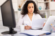 © JackF - Office woman worker is working with documents and laptop in the office