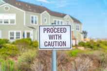 Proceed With Caution Sign Post In A Residential Area At Southern California