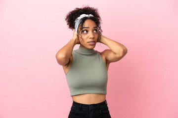 Wall Mural - Young latin woman isolated on pink background frustrated and covering ears