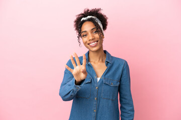 Sticker - Young latin woman isolated on pink background happy and counting four with fingers