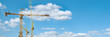 © JYPIX - Panorama with many tower cranes in clear blue sky with clouds
