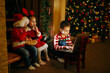 © ShunTerra - Children communicate by videolink on notebook with Santa Claus before Christmas.