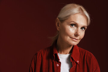 Wall Mural - Mature blonde woman wearing shirt posing and looking at camera