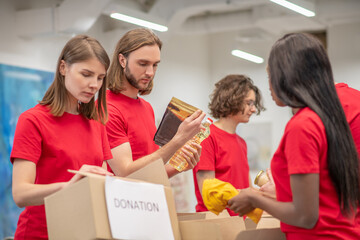 Young people working in a donations distribution center