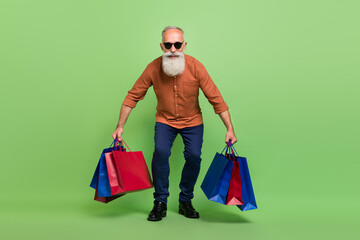 Full body photo of aged man shopping black friday discount eyewear isolated over green color background