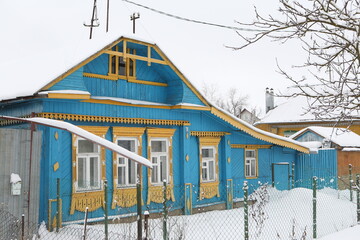 Wall Mural - Vintage wooden rural house with ornamental windows, carved frames in Ivanovo city, Russia. Russian traditional folk style in architecture. Russian village. Ivanovo architectural landmark, monument