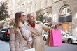 © Ihor - Mature female friends walking with shopping bags, choosing next fashion store to walk in to