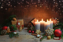Fourth Advent, Four Candles Are Lighted, Christmas Decoration And Gifts On Rustic Wooden Planks Against A Dark Brown Background With Copy Space, Selected Focus