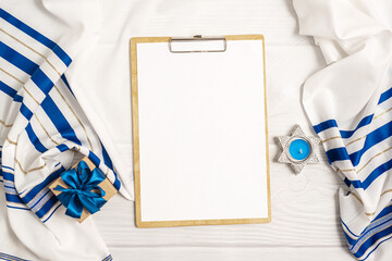 Jewish holiday Hanukkah concept with clipboard mockup gift box over white background