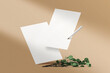 Clean minimal paper A4 mockup floating with pen and leaves