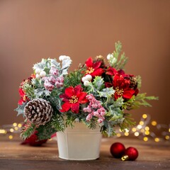 Christmas flower bouquet with red poinsettia, pine cones and spruce branches, festive arrangement on brown background with bokeh lights