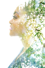 Wall Mural - A profile portrait of an attractive woman combined with foliage. Double exposure.